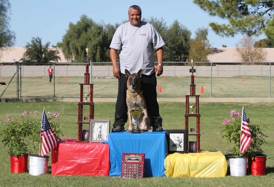 Richard Bonilla on competition podium with German Shepherd